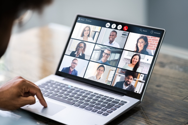 woman looking at a laptop screen with a local webinar displayed