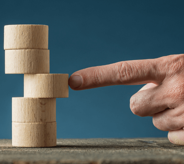 man pushing a round building block into place