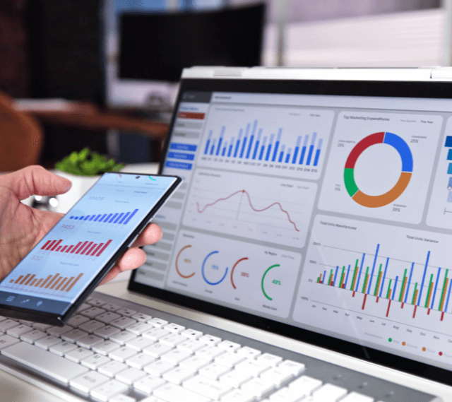 computer screen showcasing business analytics through bar graphs, charts, and tables